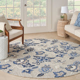 Blue-gray round rug with ornate floral and medallion pattern, soft woven texture