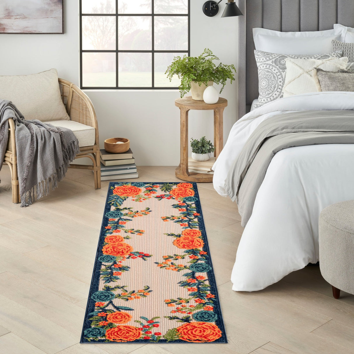 Rectangular floral rug with orange rose clusters and blue vines on light beige
