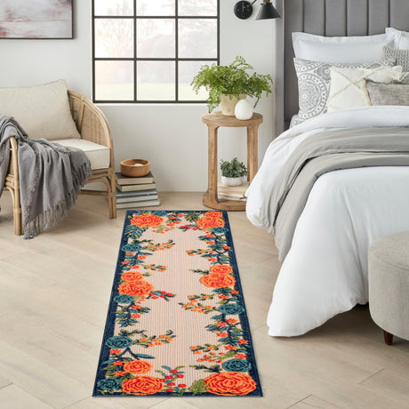 Rectangular floral rug with orange rose clusters and blue vines on light beige
