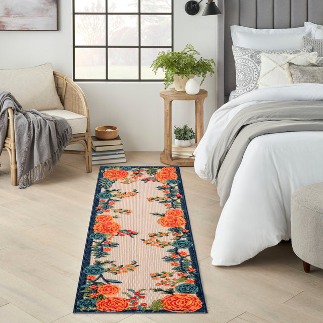 Rectangular floral rug with orange rose clusters and blue vines on light beige