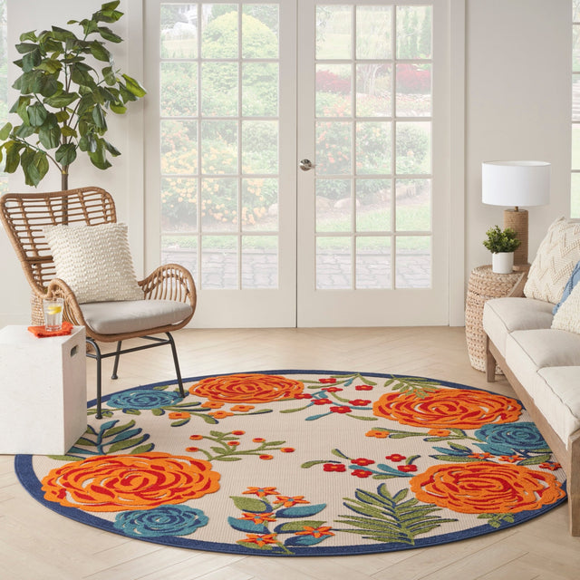 Round floral rug with large orange roses and blue border on light beige