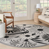 Round black-and-white floral rug with scalloped daisy motifs