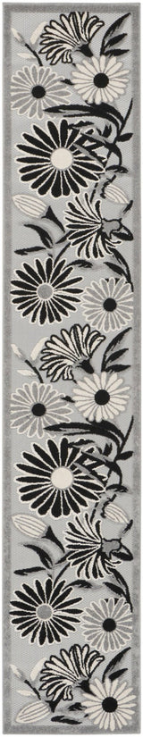 Black-and-white floral rug with layered daisy and leaf linework, close-up