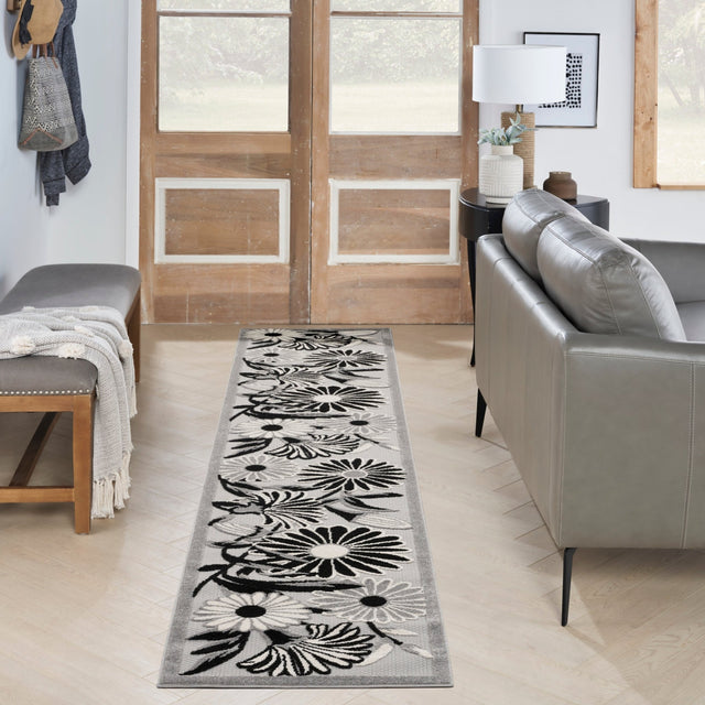 Rectangular black-and-white floral runner rug with bold daisy pattern