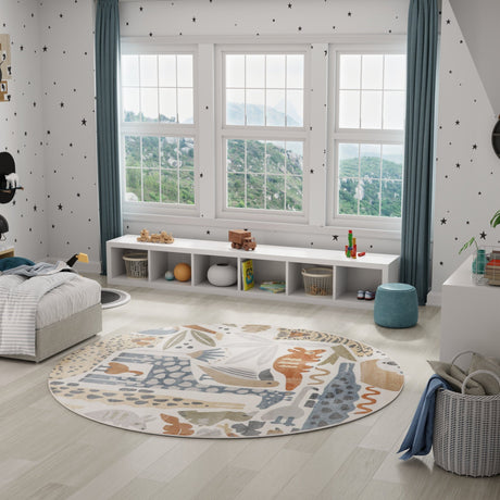 Ivory round area rug with animal safari motifs in blue, rust, and tan
