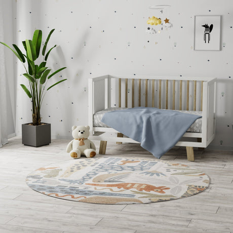 Ivory round area rug with animal silhouettes and paw-print style accents in blue
