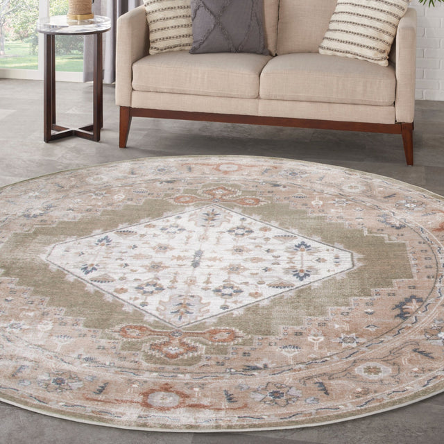 Round sage multi area rug with central diamond motif and detailed border in beige and blue