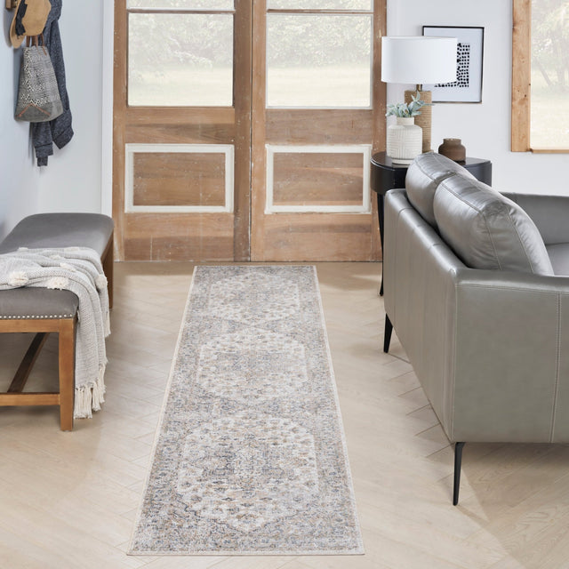 Silver grey runner rug with central medallion and scrolling motifs in blue and tan