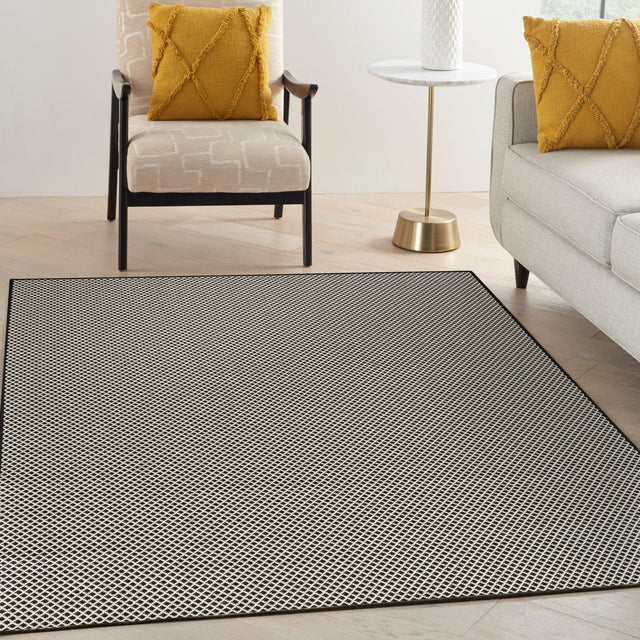 Black and white lattice area rug with textured grid pattern border