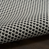 Black and white lattice rug with looped texture along the edge