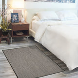Black and white geometric area rug placed beside a bed in bedroom