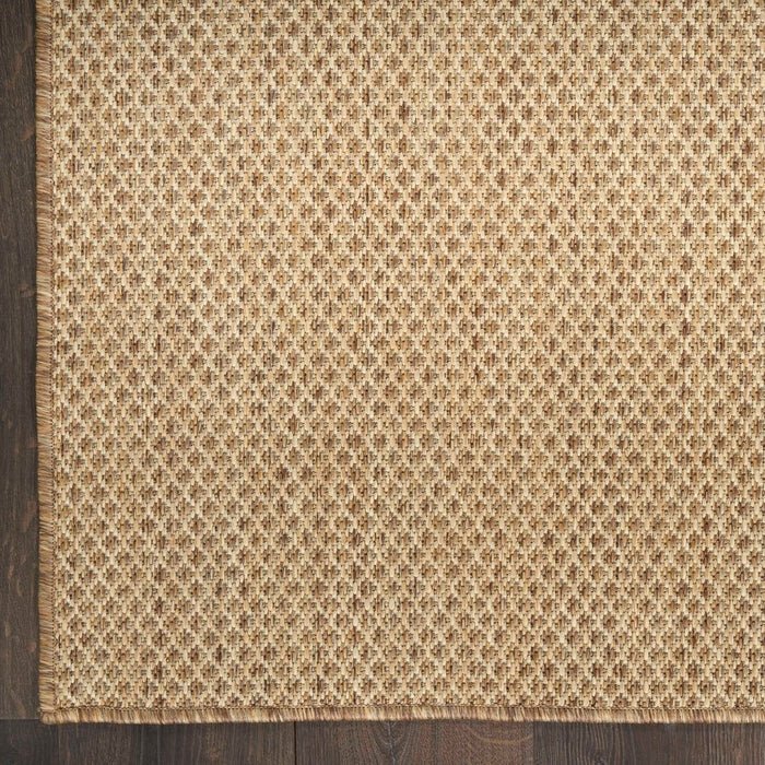 Tan jute rug with dense woven diamond pattern close-up