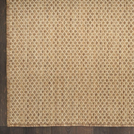 Tan jute rug with dense woven diamond pattern close-up