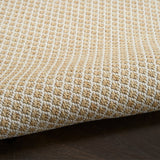 Close-up of natural woven rug with dense lattice stitching and textured pile