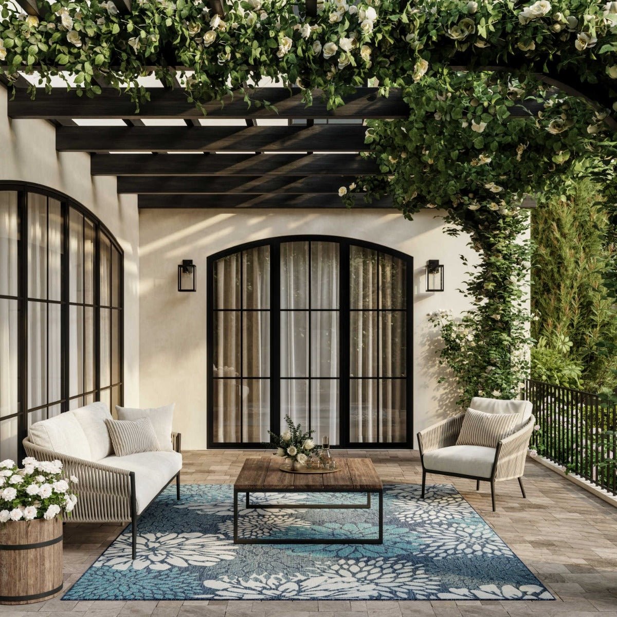 Navy and light blue rectangular floral area rug centered on outdoor patio seating