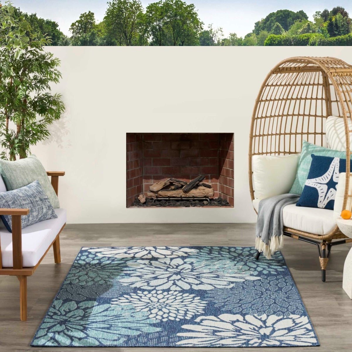 Navy and light blue floral area rug laid in an outdoor patio seating area