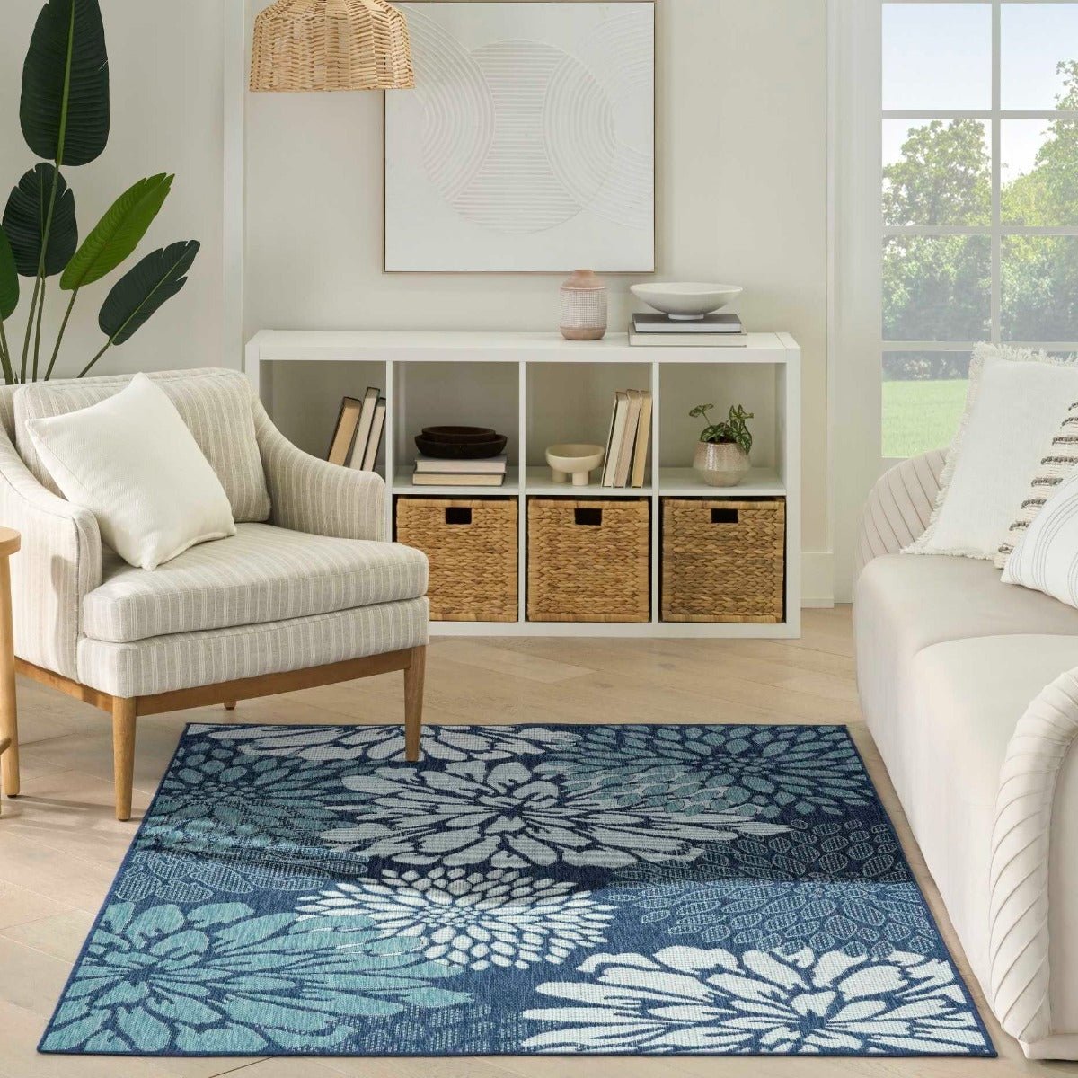Navy and light blue contemporary floral area rug shown in a living room setting