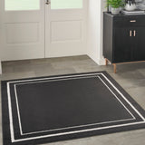 Black and ivory rectangular rug with double-line inner border