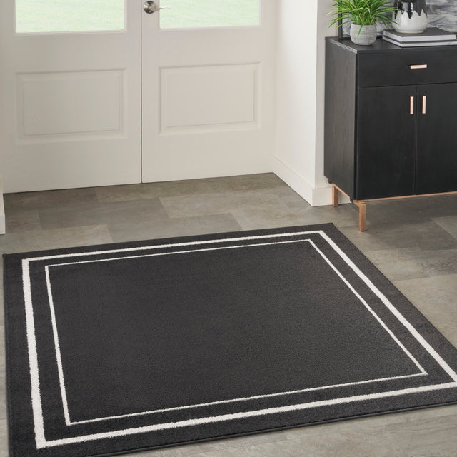 Black and ivory rectangular rug with double-line inner border
