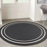 Black and ivory round rug with concentric oval stripes