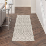 Rectangular light grey rug with textured geometric lattice pattern