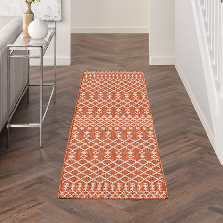 Terracotta rectangular rug with repeating white diamond lattice pattern