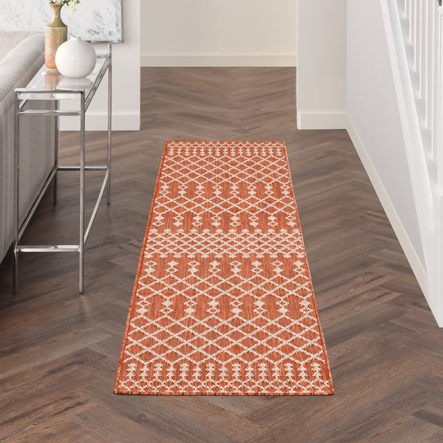 Terracotta rectangular rug with repeating white diamond lattice pattern