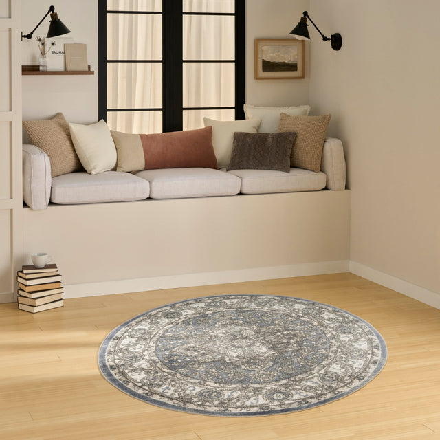 Blue and gray vintage-style round area rug on light wood flooring