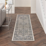 Rectangular runner ivory and blue rug with ornate central pattern and border