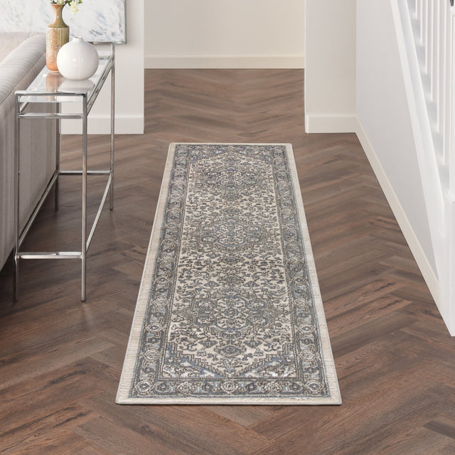 Rectangular runner ivory and blue rug with ornate central pattern and border