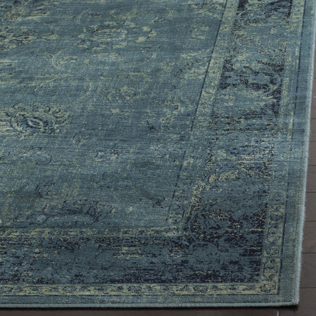 Vintage-style rug surface in blue-teal with distressed ornamental lines and texture