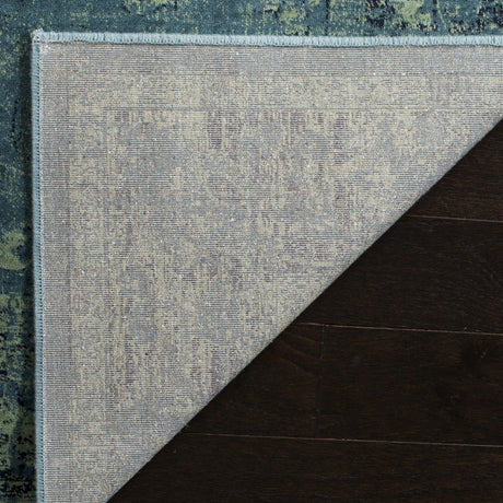 Vintage-style rectangular rug with light blue and teal distressed pattern