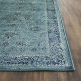 Vintage-style rectangular rug in blue with distressed medallion pattern and border