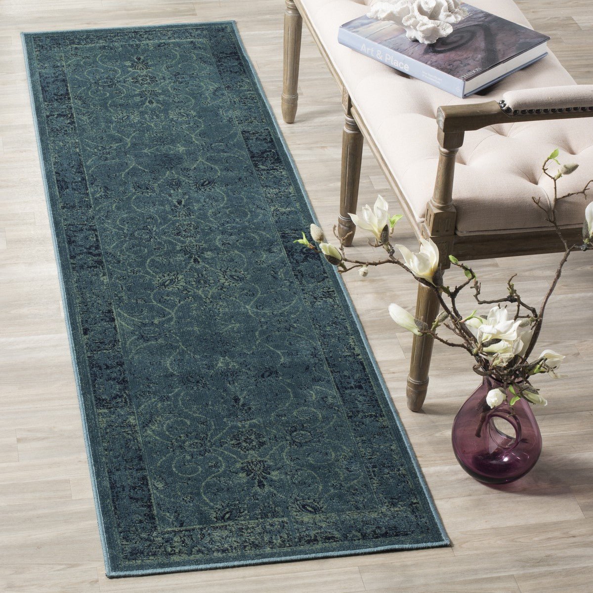 Vintage-style runner rug in deep teal with ornate distressed motif