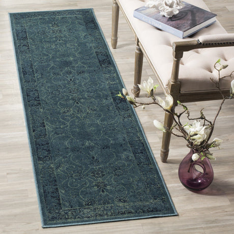 Vintage-style runner rug in deep teal with ornate distressed motif