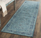 Vintage-style runner rug in light blue with ornate distressed design and border