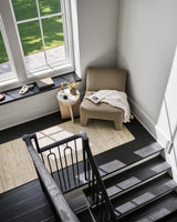 Handmade area rug in light beige with a subtle distressed geometric pattern