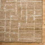 Handmade rug in tan with cream abstract stripes and speckled texture