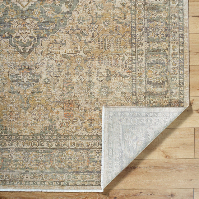Surya Renaissance rug corner with blue and beige geometric pattern, folded edge visible