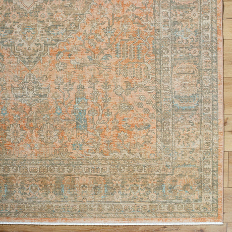 Handmade rug with distressed geometric pattern, beige center, teal accents, rust border