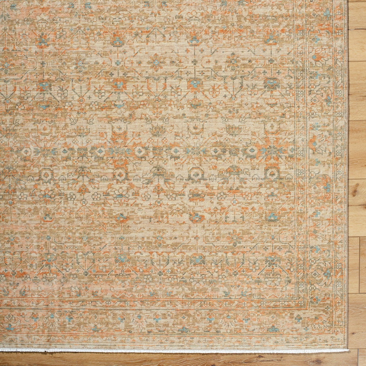 Handmade rectangular rug with ornate vintage pattern, beige tan with orange and blue accents